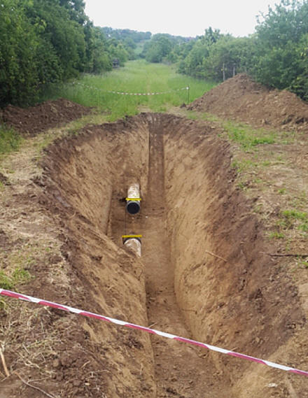 Odkopávání potrubí, pokládka nového potrubí, výřezy potrubí, izolace potrubí a jiskrové zkoušky.